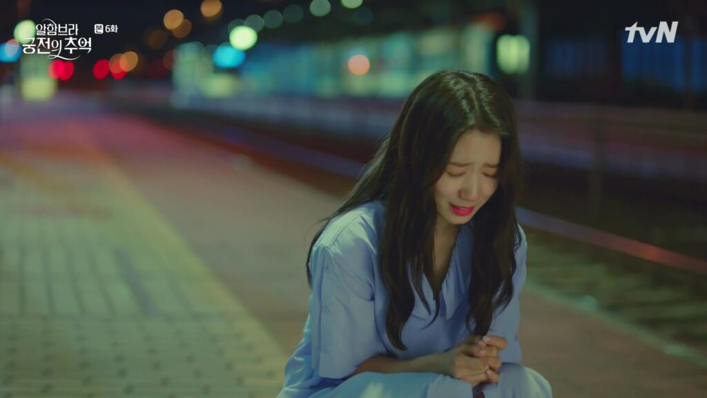The female lead of Memories of the Alhambra is kneeling on the road. Crying.