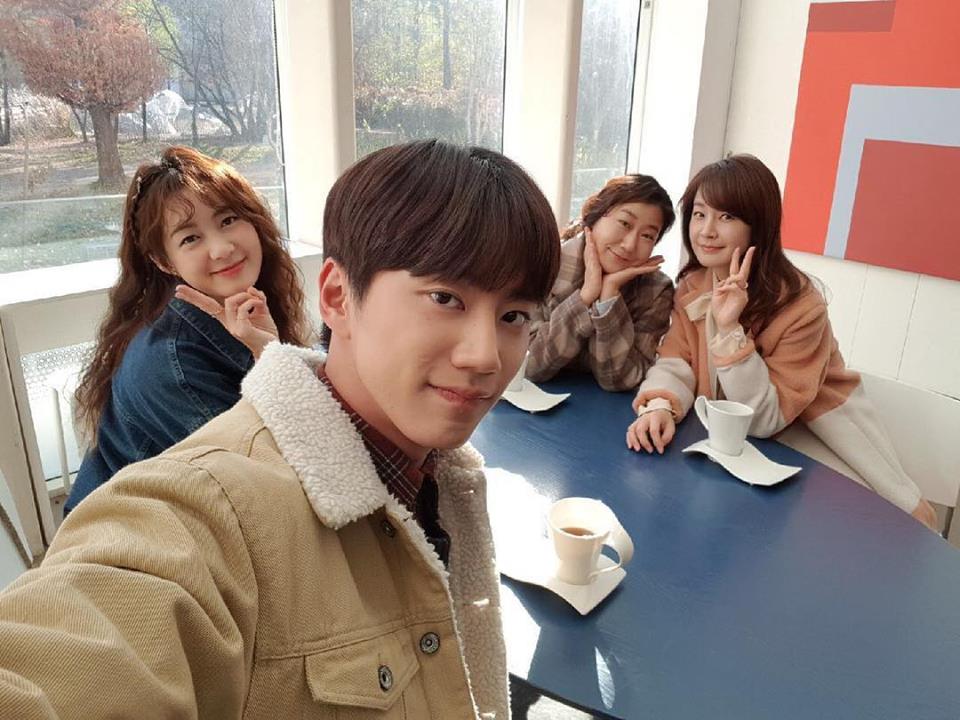 The members of the Avenger's Club at their favourite cafe smiling for a selfie