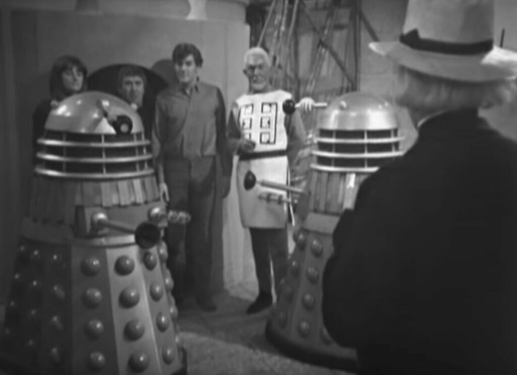 The Doctor faces the Daleks and Chen who have Steven, the Monk and Sara hostage