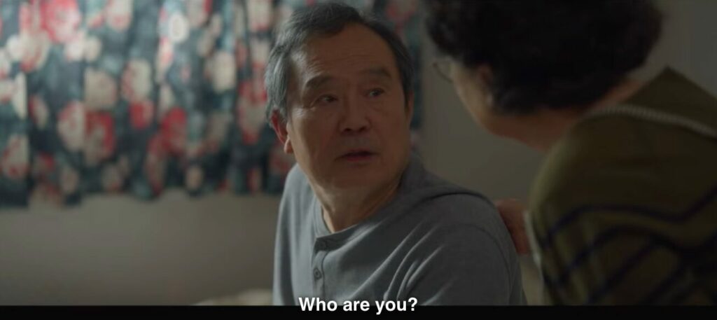 Deok-chul looks at his wife in confusion and asks, "Who are you?"