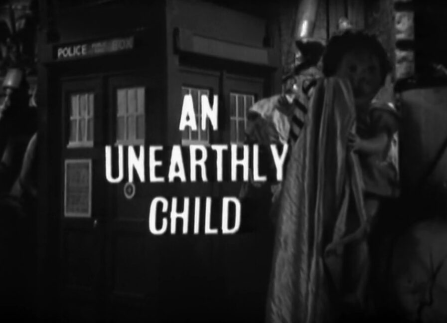 A black and white shot of a police box in a junkyard with the titles, "An Unearthly Child" superimposed on it.