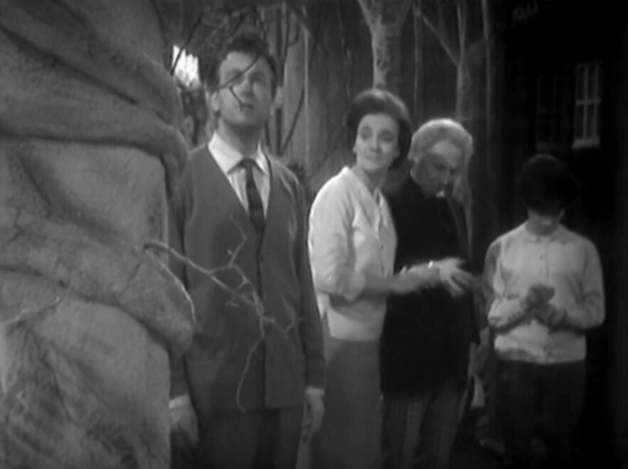 Ian, Barbara, The Doctor and Susan standing looking fascinated by an alien planet with the TARDIS behind them.