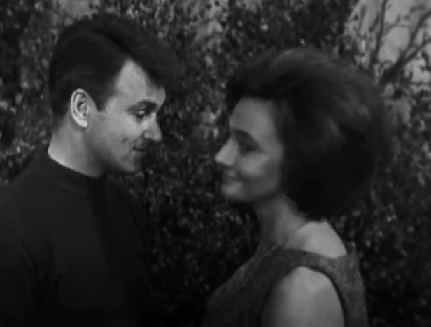 Ian and Barbara stand very close looking at each other with deep affection. 