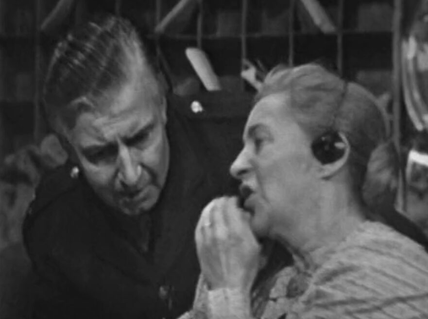 A gossipy telephone operator tells a police officer about her suspicions.