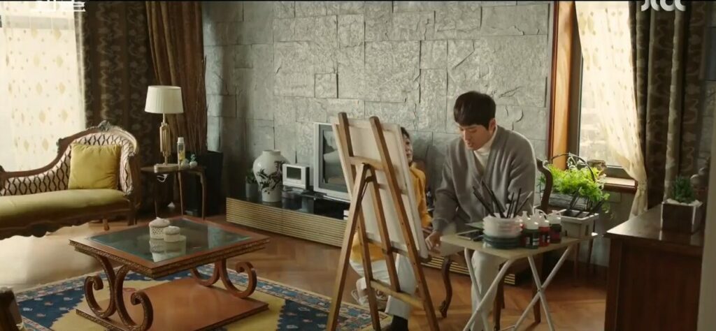 Jeong-jae paints fawns in a lovely homey light-filled room while his mother begs him on his knees to stop and get a promotion instead