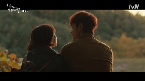 Our two leads in a tender moment while watching a sunset