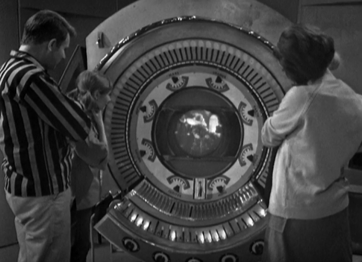 Ian, Vicki and Barbara stare at the new Time and Space Visualier. It's a giant futuristic wheel with loads of buttons and indicators surrounding a tiny little TV scrren.