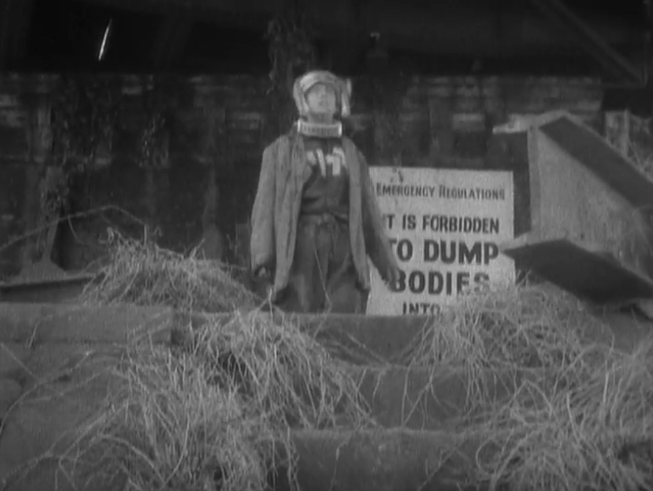 A tortured man with a mechanism on his head lurches toward a river with a sign behind him that says, "Emergency Regulations: It is forbidden to dump bodies into the river"