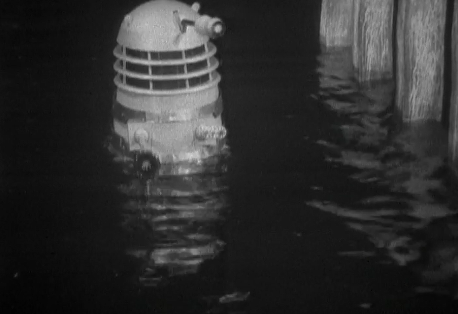 A Dalek appears out of the water of the Thames