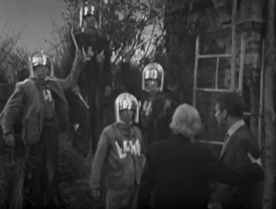 The Doctor and Ian are face to face with three men with metal helmets that are controlling them