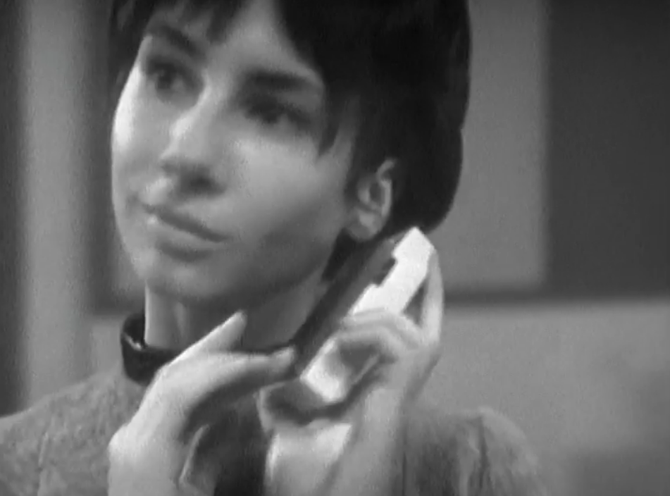 Susan listens to a portable transistor radio with an ethereal look on her face.