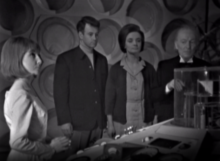 The TARDIS crew seemingly transfixed by the column in the console room