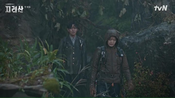 The two leads of Jirisan hiking through the mountains in a typhoon. They look bedraggled